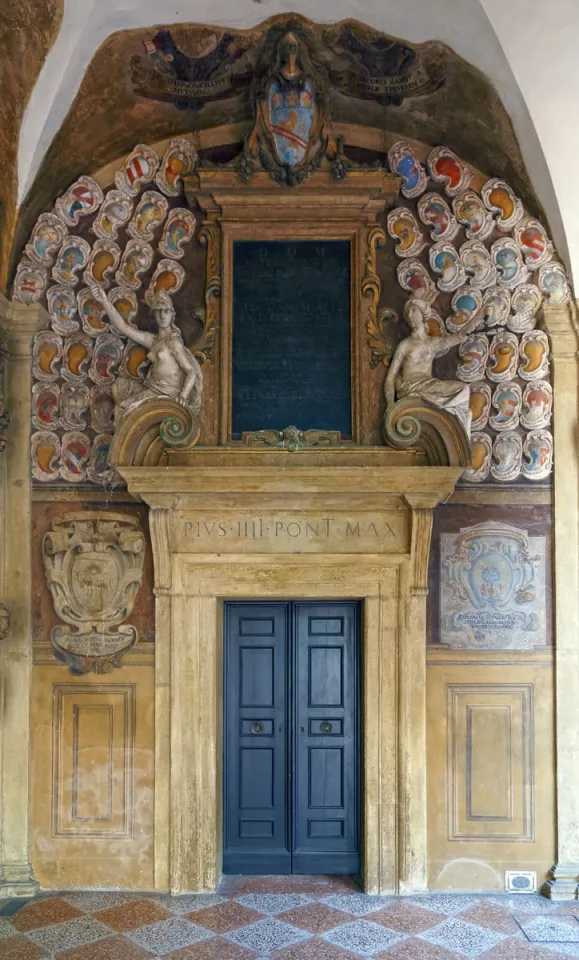 Archiginnasio Palace, first floor arcade with door and coat of arms reliefs